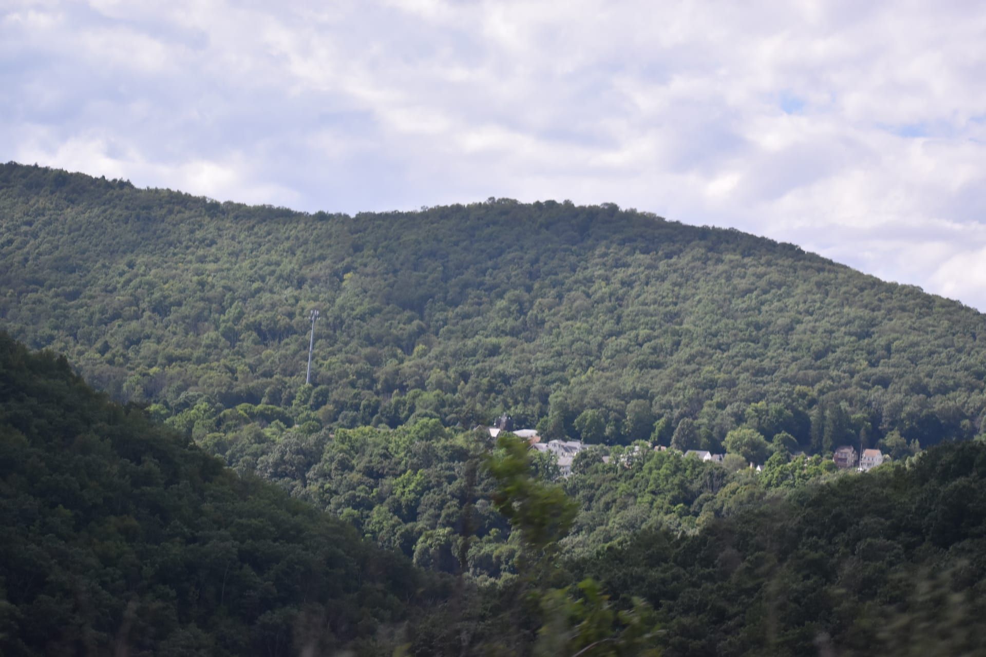 Forested mountain with village nestled below
