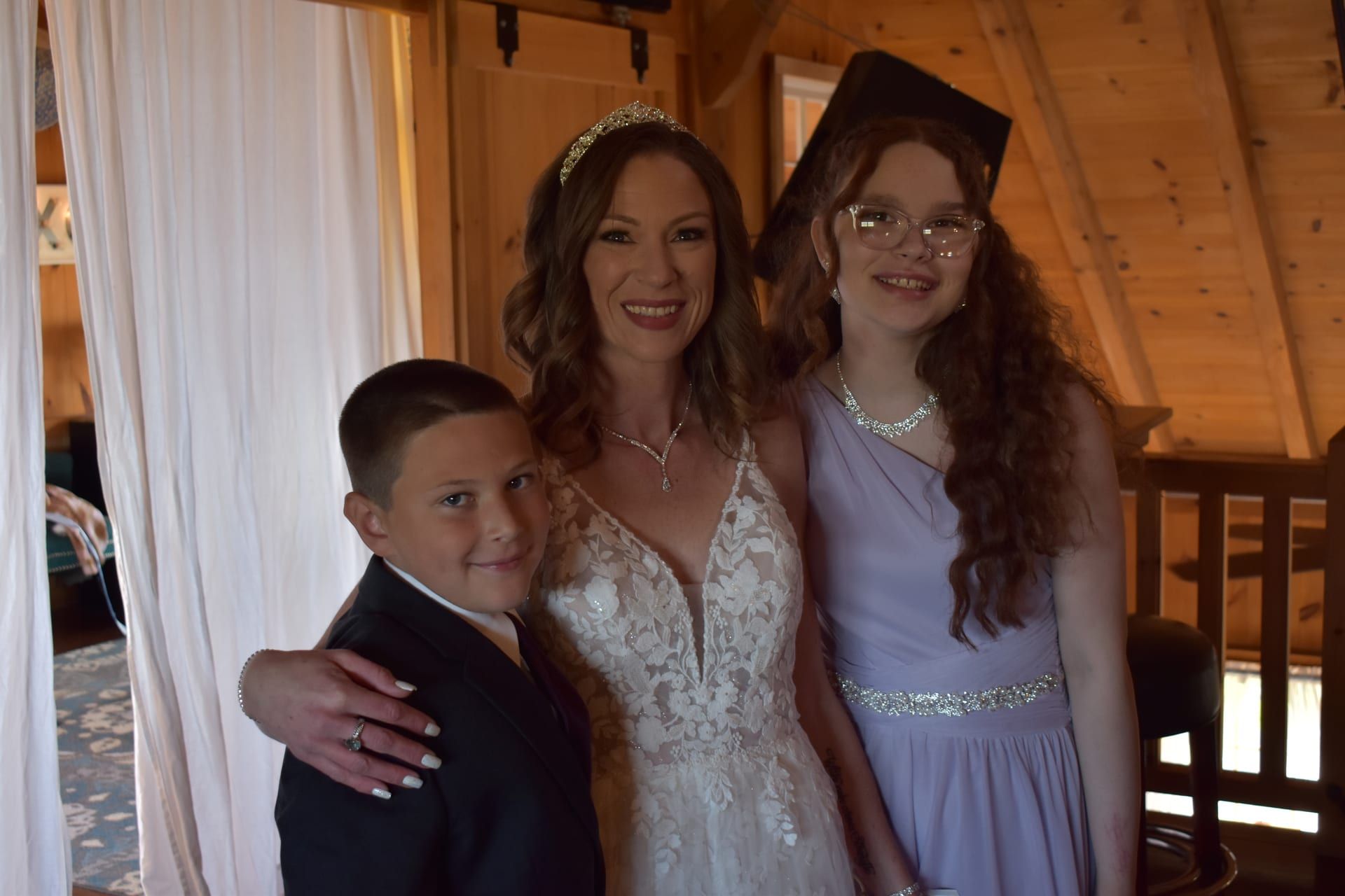 Bride with children in rustic cabin setting